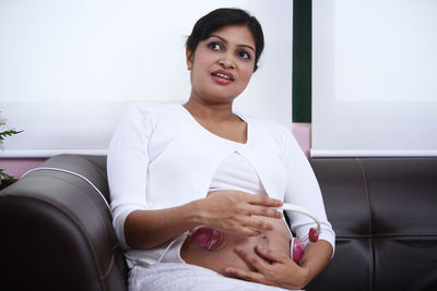 Portrait of a young woman sitting at home