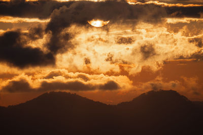 Scenic view of dramatic sky at sunset