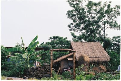 House on field against clear sky