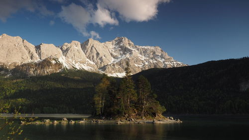 Scenic view of lake and mountains against sky