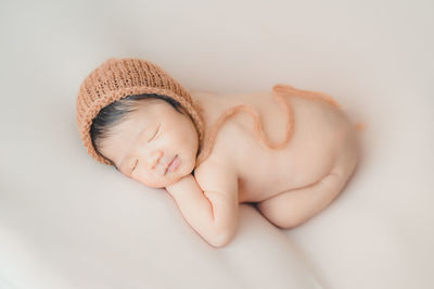 High angle view of baby sleeping on bed