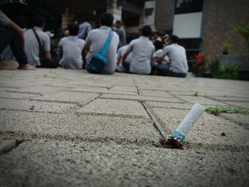 Close-up of cigarette butt on footpath