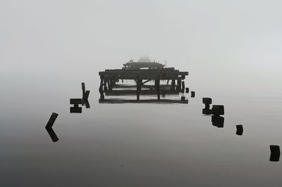 Lifeguard hut on lake against sky