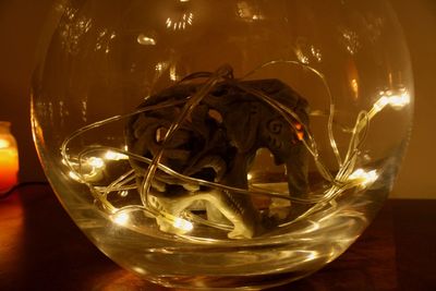 Close-up of illuminated glass on table