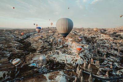 Hot air balloon flying over water against sky