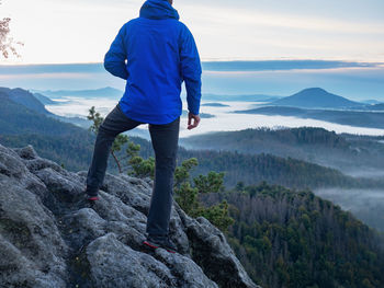 Rear view of man standing on mountain