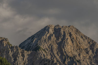 Low angle view of rocky mountain against sky