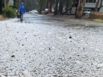 Man walking on wet road