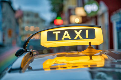 Close-up of yellow sign on car