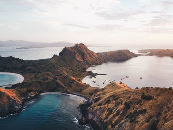 Scenic view of sea and mountains against sky