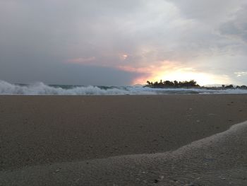 Scenic view of beach against sky during sunset