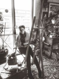 Portrait of happy young woman sitting on floor