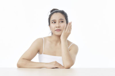 Portrait of woman against white background