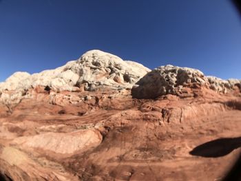 Low angle view of mountain against clear blue sky