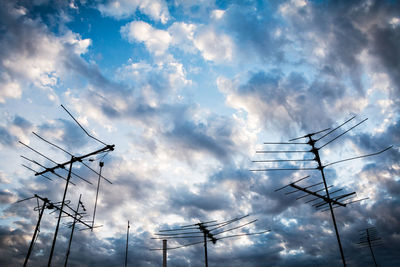 Low angle view of electricity pylon against sky