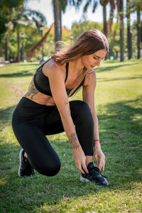 Side view of woman exercising in park