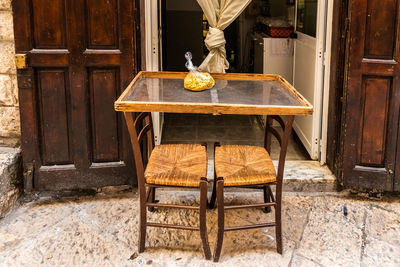 Wooden table and chairs in house during winter