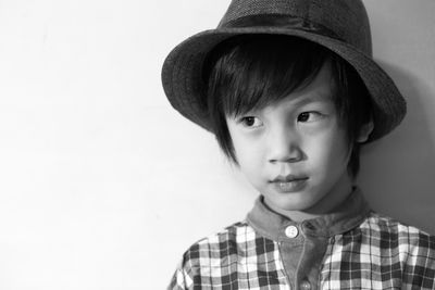 Portrait of boy wearing hat against white background