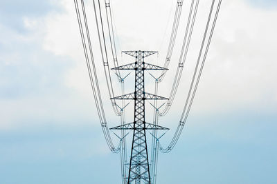 Low angle view of electricity pylon against sky