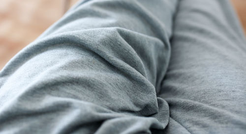 Low section of man relaxing on bed