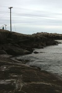 Rocks on beach against sky