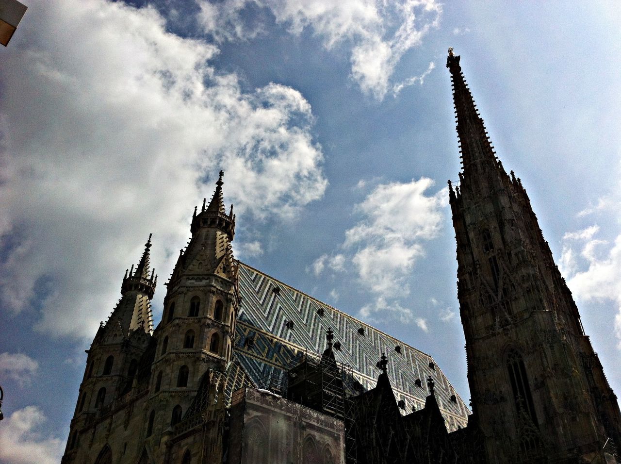 religion, architecture, low angle view, place of worship, building exterior, built structure, sky, spirituality, church, cloud - sky, cathedral, history, tower, cross, old, steeple, cloud, cloudy