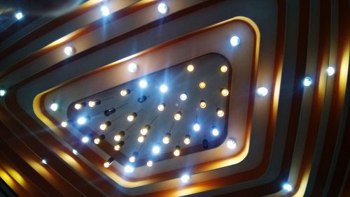 Low angle view of illuminated lights on ceiling