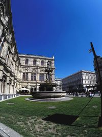 Buildings in city against blue sky