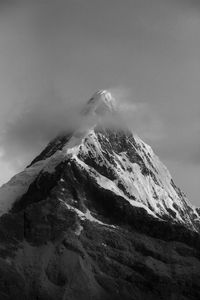 Low angle view of snow on mountain against sky