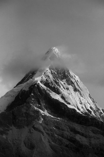 Low angle view of snow on mountain against sky