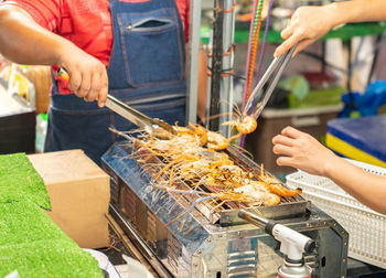 Midsection of man preparing food