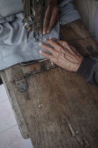 Cropped hands of tailor stitching textile