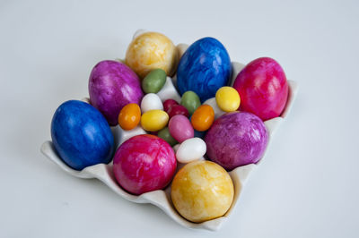 Close-up of multi colored candies against white background
