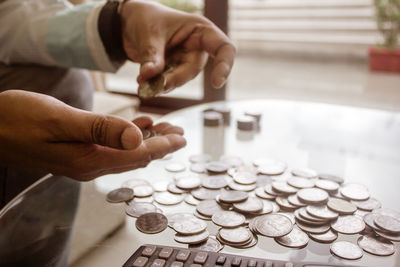 Cropped hands holding coins