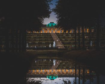 Reflection of trees and buildings in lake