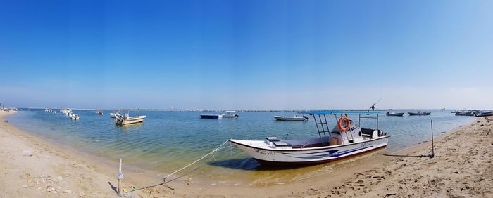 Boats moored on sea against sky