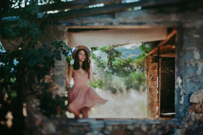 Girl in tumbled down cottage