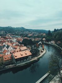 High angle view of townscape by canal against sky