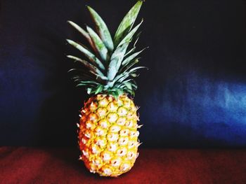 Close-up of fruits on table against black background