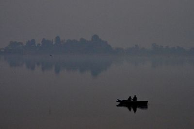 Silhouette of of boat on lake