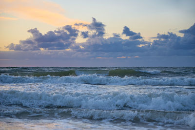 Baltic sea beach with waves at sunset