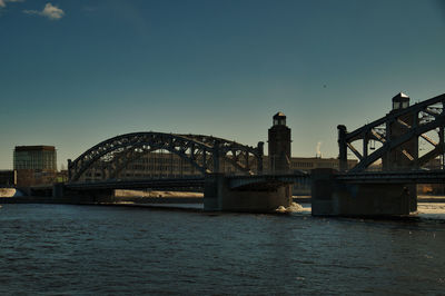 Bridge over river against sky at night