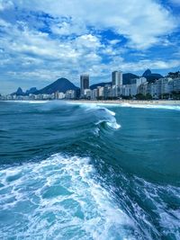 Scenic view of sea and buildings against sky