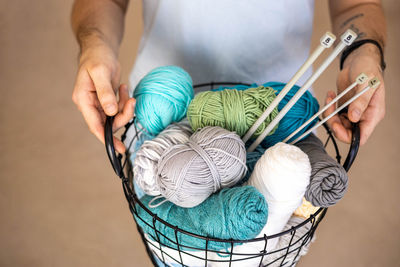 Midsection of man holding wool