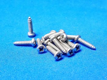 High angle view of objects on table against blue background