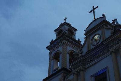 Low angle view of clock tower against sky