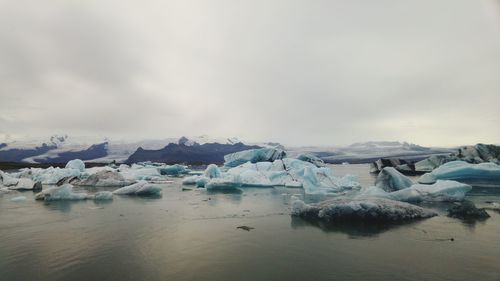 Scenic view of frozen lake against sky