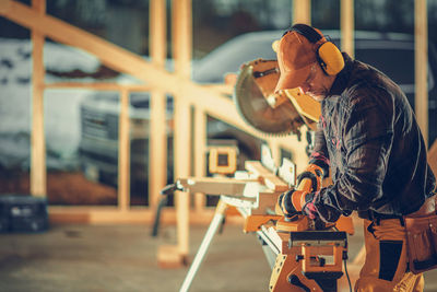 Side view of man working at construction site