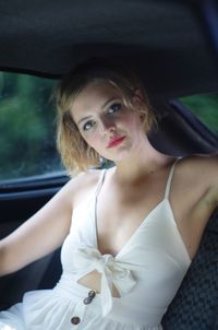 Portrait of beautiful young woman in car