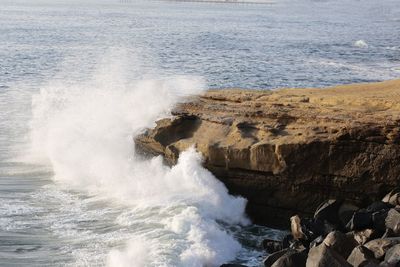 Waves splashing on rocks at shore